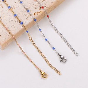 Detail of 18k gold and silver O-chain bracelets with colorful enamel beads and lobster clasp