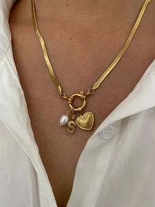 Detail of gold snake chain necklace with freshwater pearl, letter S, and heart pendants
