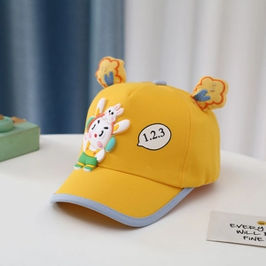 Detail of yellow toddler baseball cap featuring 3D cartoon rabbit and cloud ornaments