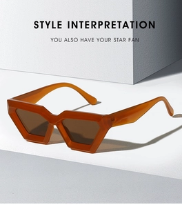 Detailed view of amber geometric sunglasses on a minimalist architectural display