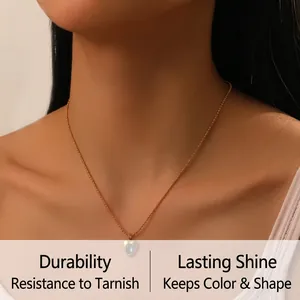 Detailed view of an oval heart-shaped moonstone pendant on a gold bead chain necklace