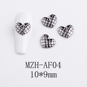 Detailed view of 10x9mm gunmetal heart nail charms with quilted pattern on a white tip