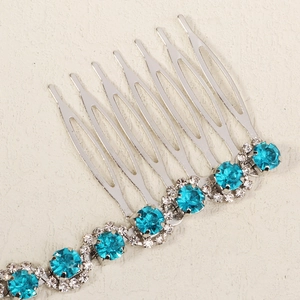 Detail of silver bridal hair comb with blue crystals and sparkling rhinestones