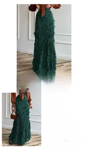 Detailed view of dark green polka dot tiered skirt with elegant ruffled layering