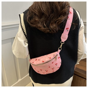 Detailed view of pink cherry print crossbody bag with adjustable wide shoulder strap