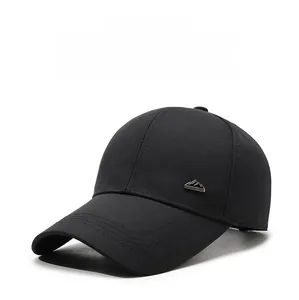 Detailed macro view of black twill cotton baseball cap with a silver mountain metal logo