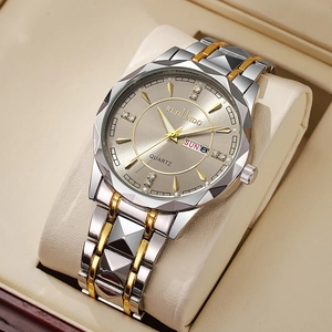 Detailed macro of a gold and silver steel watch with a champagne dial and calendar