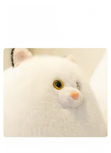 Macro detail of plush white Persian cat toy showing realistic yellow eyes and fluffy fur