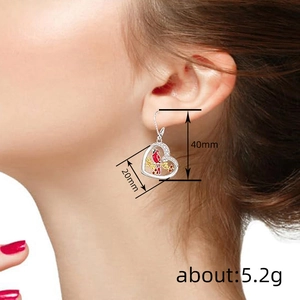 Elegantly worn heart drop earrings with red cardinal bird and plum blossom pattern