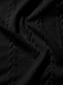 Macro shot of heavy grey cable knit fabric with a dense and textured vintage pattern