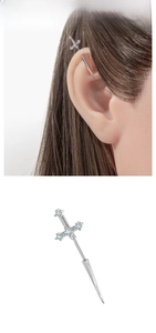 Detail of silver sword cross ear stud featuring micro-inlaid light blue zircon crystals