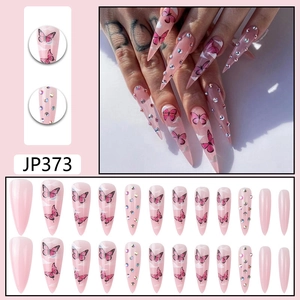 Detail view of pink stiletto press-on nails JP373 with cloud, butterfly and rhinestone decor