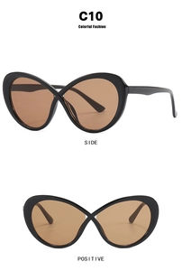 Macro detail of oval cross frame glasses in black with stylish brown tinted lenses