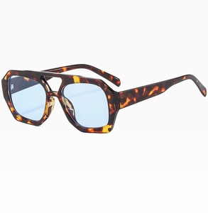 Close-up of tortoise frame sunglasses with light blue lenses and double bridge design