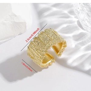Detailed view of gold irregular textured wide ring with 1.38cm width and 2.5cm diameter