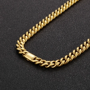 Detail shot of a polished gold Cuban chain necklace with a secure rectangular clasp