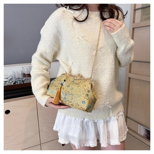 Elegant embroidered evening bag with tassel and gold chain strap