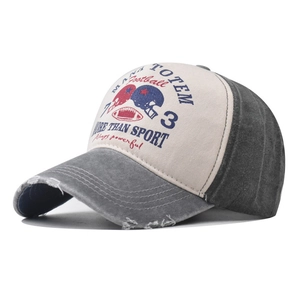 Detail view of distressed baseball cap with football print and Mana Totem lettering