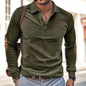 Detail of olive green corduroy polo shirt with brown elbow patches and ribbed texture