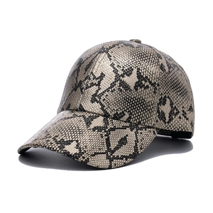 Detailed macro view of the realistic snake skin texture on the fashion baseball cap fabric