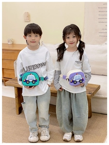 Detailed view of green and purple cartoon car chest bags worn by children models