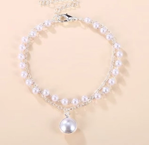 Detail of double-layer pearl necklace with large round pendant and lobster clasp