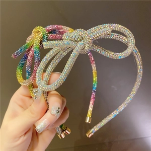 Macro shot of colorful and silver rhinestones on a sparkling handmade bow headband