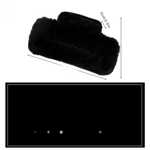 Detail view of large black plush hair claw clip showing 11.5cm dimensions and fuzzy texture