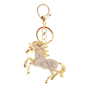 Detailed view of the sparkling crystal horse keychain with golden finish and alloy structure