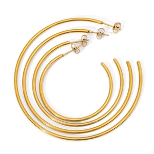 Set of four gold oversized hoop earrings in varied sizes with polished metal finish