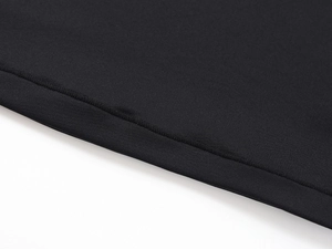 Close-up of fine double-stitching on the hem of a black skin-friendly athletic T-shirt
