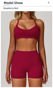 Raspberry red sports bra and high-waisted shorts set shown on a fitness model
