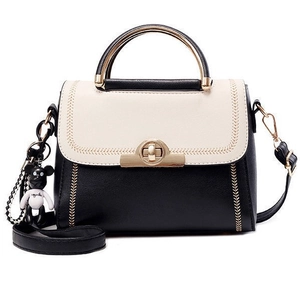 Chic beige and black PU leather crossbody handbag with gold clasp and cute charm accessory