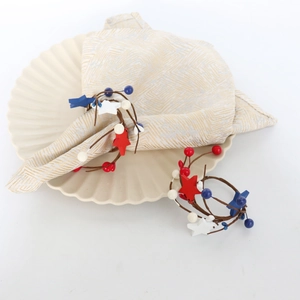 Detail of USA Patriotic napkin rings with red white blue stars on woven vine loop
