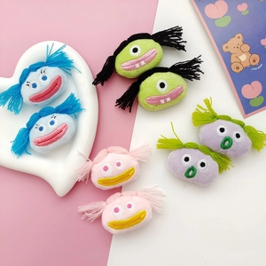Cute plush monster hair pins and brooches in blue, green, pink, and purple colors
