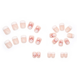 Pink and white gradient press-on nails with camellia flower patterns and French tips
