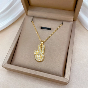 Luxurious gold titanium steel necklace with a crystal-encrusted victory hand pendant