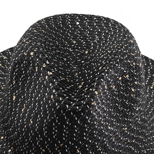 Close-up of black straw sun hat featuring dense twill weave and gold sequin accents