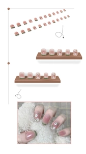 Short square press-on nails with pink blush gradient and green floral French tips