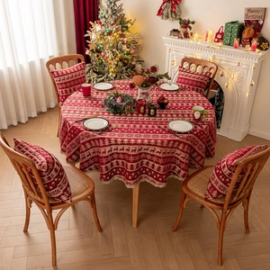 Red Christmas tablecloth and pillows with reindeer and tree patterns for holiday decor