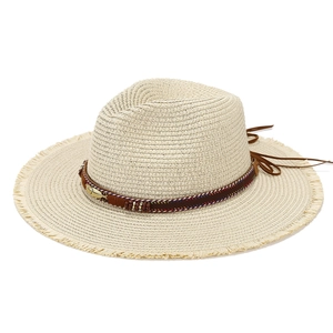 Straw sun hat with bohemian feather band and fringe brim for beach vacation