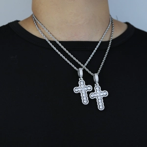 Detail of silver twisted rope chains with hollow cross pendants inlaid with zircons