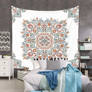 Symmetric mandala floral tapestry displayed on a bedroom wall above a cozy double bed
