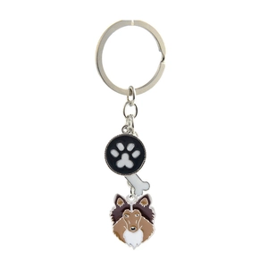 Metal dog keychain with black paw print charm, white bone, and brown Collie head on ring