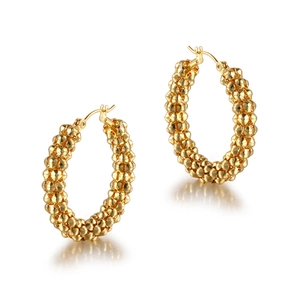 Vintage style gold hoop earrings with beaded texture on a white background