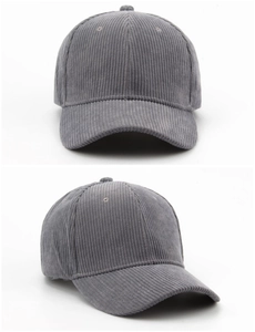 Macro detail of grey corduroy baseball cap showing textured ribbed fabric and seams