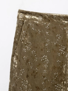 Detail of olive gold velvet suit pants with metallic silver floral print and side pockets