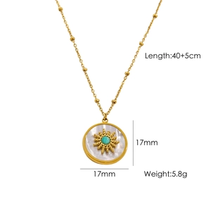 Detail of gold sun necklace with turquoise and white shell pendant measuring 17mm