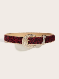 Close-up of red leopard print belt with rhinestone buckle and gold chain edging