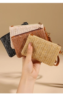 Close-up of four lightweight straw woven coin purses in black, beige, brown, and khaki
